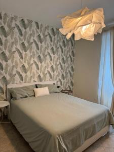 a bedroom with a large bed with a wall at A Un Passo Dal Lago in Lesina