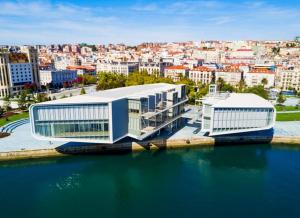 a large building next to a body of water at Hospedaje Botin in Santander +29 photos