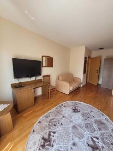a living room with a couch and a flat screen tv at Dworek Biesiadny in Radzewice