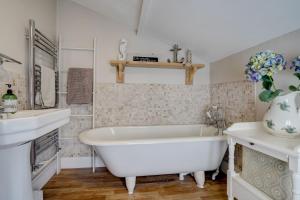 une salle de bain blanche avec une baignoire et un lavabo dans l'établissement April Cottage by Winterton Cottages, à Winterton-on-Sea 10 autres photos