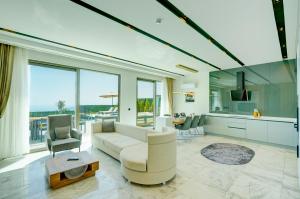 a living room with a couch and a table at Villa Pluto 1 - PLANET LUXURY VILLAS in İslâmlar