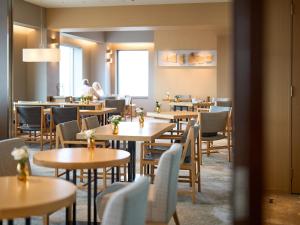 a dining room with wooden tables and chairs at Cerulean Tower Tokyu Hotel, A Pan Pacific Partner Hotel in Tokyo