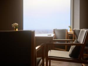a room with chairs and a table and a window at Cerulean Tower Tokyu Hotel, A Pan Pacific Partner Hotel in Tokyo