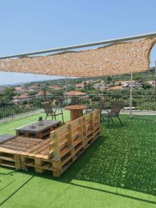 a patio with a table and chairs under a pavilion at Blue Diamond in Chrani
