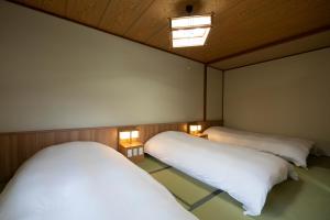 Voodi või voodid majutusasutuse Hirayukan toas