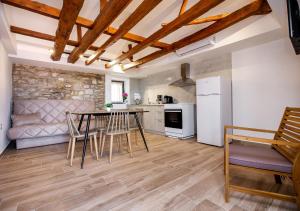 a kitchen and living room with a table and chairs at Theros Easy Living in Theologos +48 photos