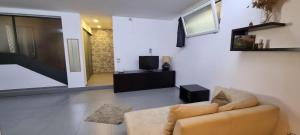 a living room with a couch and a tv at GiaVa Apartment in Baronissi