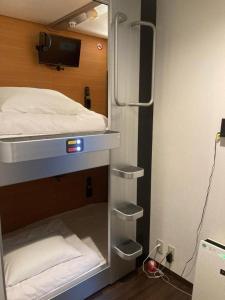 Postel nebo postele na pokoji v ubytování カプセルホテル41