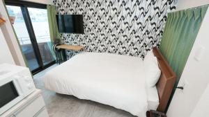 Uma cama ou camas num quarto em CoCo SPACE