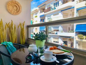 a table with a tray of food on a balcony at Casa Alicia Altea by DelucaCo in Altea