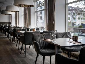 a row of tables and chairs in a restaurant at Quality Hotel Grand Kristiansund in Kristiansund