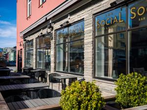 a restaurant with tables and chairs in front of a building at Quality Hotel Grand Kristiansund in Kristiansund