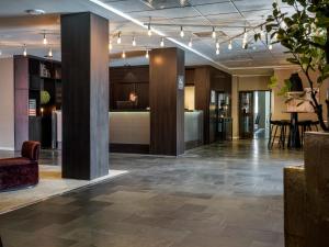 an office lobby with a woman sitting at a desk at Quality Hotel Grand Kristiansund in Kristiansund