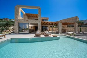 a villa with a swimming pool and a house at Lithos Art Villas in Sarlata