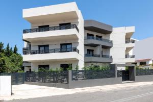 a white building with balconies on a street at Aegean Escape Luxury Apartment in Rhodes Town