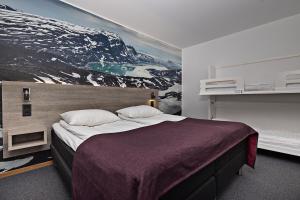 sypialnia z dużym łóżkiem z obrazem na ścianie w obiekcie Comfort Hotel Umeå City w mieście Umeå