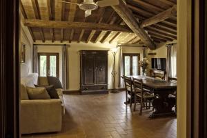 a living room with a couch and a dining room table at Borgo Dolciano in Chiusi