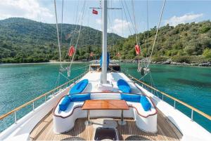 a boat with a table on the deck in the water at Your accommodation in Kotor bays in Kotor +12 photos