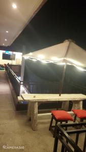 a wooden table with two chairs and an umbrella at Ceria House Ungasan Uluwatu in Uluwatu +111 photos