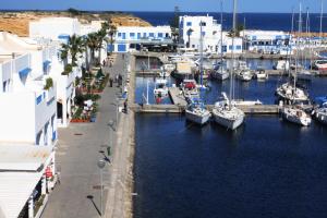 a marina with boats in the water next to buildings at Marina Cap Monastir- Appart'Hôtel in Monastir