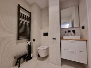 a white bathroom with a toilet and a sink at VibesCoruña-Rubine 20 in A Coruña +12 photos