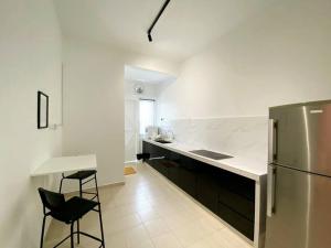 a kitchen with a refrigerator and a table and chairs at IKEA Modernism House 10Pax`Near Icon City in Bukit Mertajam