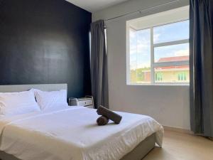 a bedroom with a white bed with a window at IKEA Modernism House 10Pax`Near Icon City in Bukit Mertajam