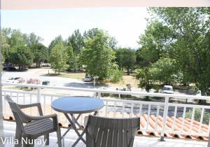 a patio with a table and chairs on a balcony at Villa Nuray in Keramoti