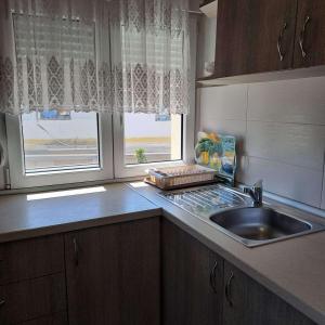 a kitchen counter with a sink and a window at Makri square apartment in Makri