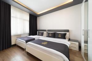 Postel nebo postele na pokoji v ubytování Bakırköy Zeugma Suit Otel
