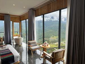 a bedroom with a view of a mountain at Lá Đỏ 2 Homestay & Coffee in Sapa