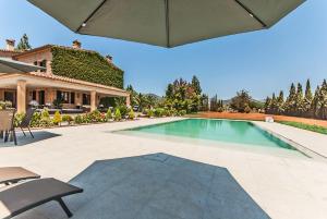 a swimming pool in the backyard of a house at Villa Santa María Dreams AWARDED 2024 in Santa Maria del Camí