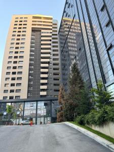 an empty street in front of tall buildings at Prishtina's Finest in Pristina