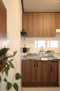a kitchen with wooden cabinets and a sink at Your-jin stay Seoul in Seoul +10 photos
