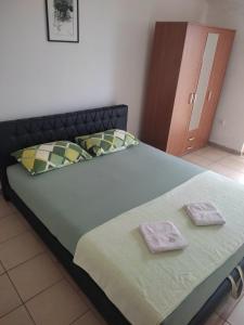 a large bed with two towels on top of it at Sara in Kamenari