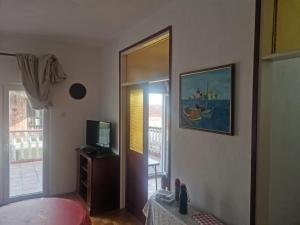 a bedroom with a bed and a mirror and a television at Uroš in Kamenari +6 photos