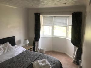 a bedroom with a bed and a window at Marina Townhouse at Harlepool in Hartlepool