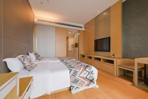 TV a/nebo společenská místnost v ubytování Snug Gaokong Jiangjing Hotel