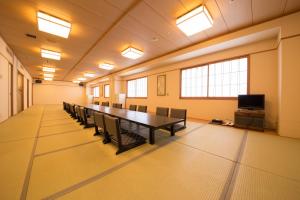 a conference room with a long table and chairs at Spa World HOTEL&RESORT in Osaka +37 photos