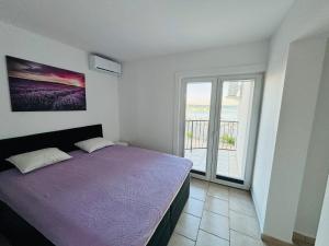 a bedroom with a bed and a large window at Apartmani Podoreški in Vir +11 photos