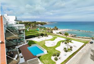 an aerial view of a resort with a swimming pool and the ocean at Apartment Josephine - Beachfront in Protaras