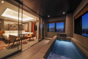 a hotel room with a swimming pool and a bedroom at Spa World HOTEL&RESORT in Osaka