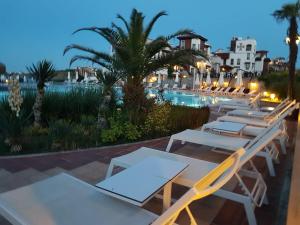 a row of tables and chairs next to a swimming pool at Bogdanov in Lozenets