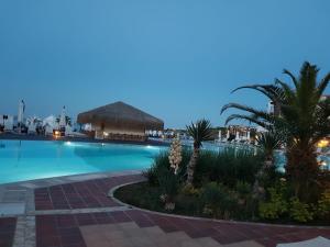 a swimming pool with palm trees and a resort at Bogdanov in Lozenets