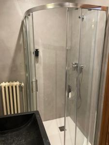 a shower with a glass door in a bathroom at Leyendas Del Pirineo in Fiscal +83 photos