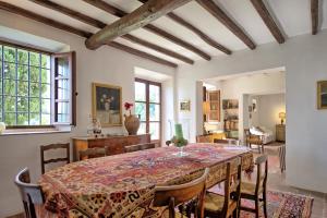 a dining room with a table and chairs at Villa Mami by PosarelliVillas in Serravalle Pistoiese