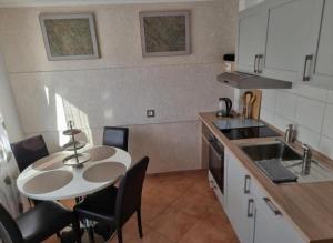 a kitchen with a table and chairs in a kitchen at Sweet Home in Wermelskirchen