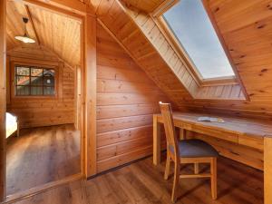 a wooden cabin with a desk and a window at Blockhaus Christoph Columbus - Meerblick in Sassnitz +8 photos