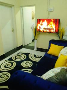 a living room with a couch and a fireplace at GG homes in Nairobi