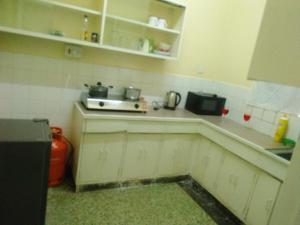 a small kitchen with a sink and a counter top at GG homes in Nairobi